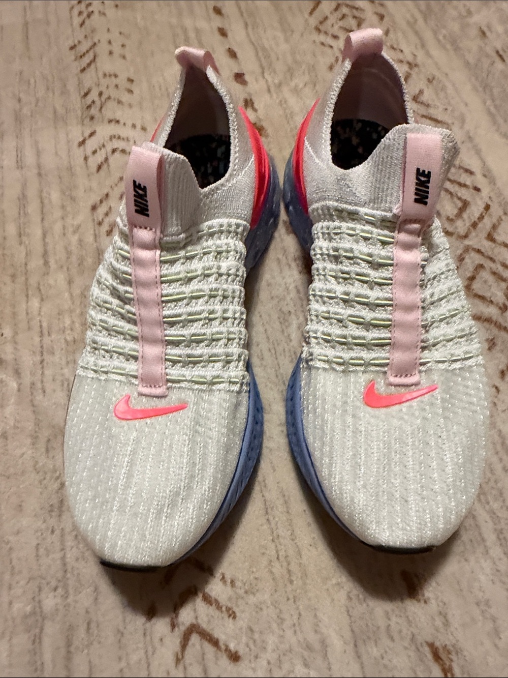 Nike Women’s Slip-On Knit Sneakers in White with Pink and Blue Accents